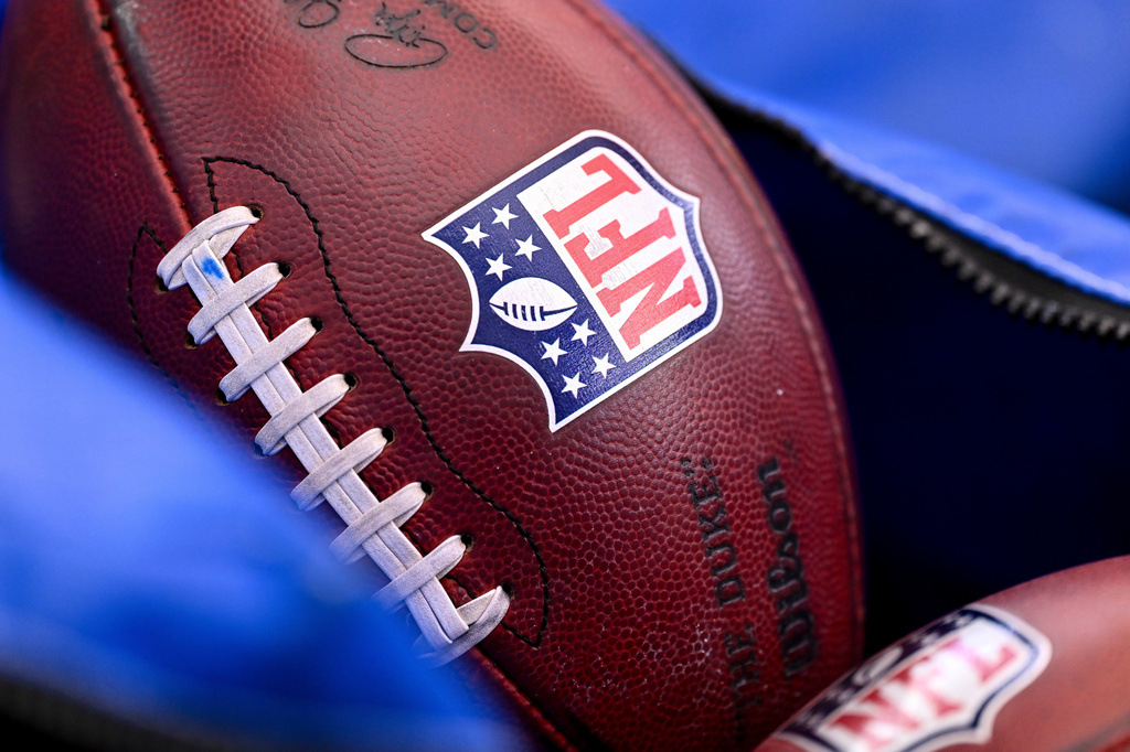Close-up of a textured football featuring the NFL shield logo in focus
