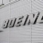 Monochrome photo of the Boeing logo on a corrugated metal wall exterior