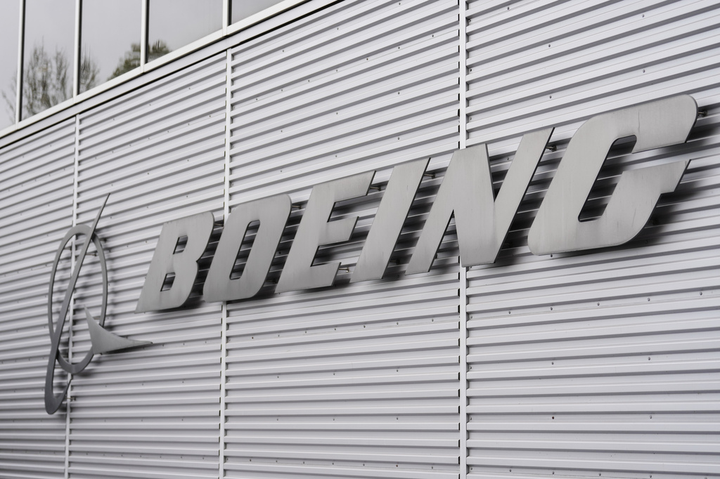 Monochrome photo of the Boeing logo on a corrugated metal wall exterior