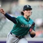 Baseball pitcher from the Seattle Mariners throwing a pitch, windup extended, with glove on his left hand and teal uniform.