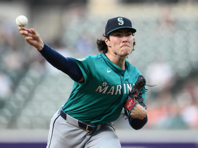 Baseball pitcher from the Seattle Mariners throwing a pitch, windup extended, with glove on his left hand and teal uniform.