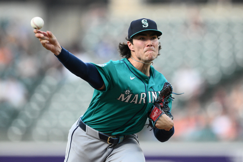 Baseball pitcher from the Seattle Mariners throwing a pitch, windup extended, with glove on his left hand and teal uniform.