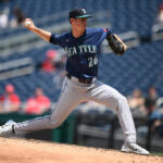 Seattle Mariners pitcher in a blue uniform delivering a pitch from the mound