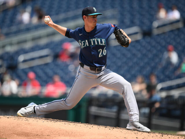 Seattle Mariners pitcher in a blue uniform delivering a pitch from the mound