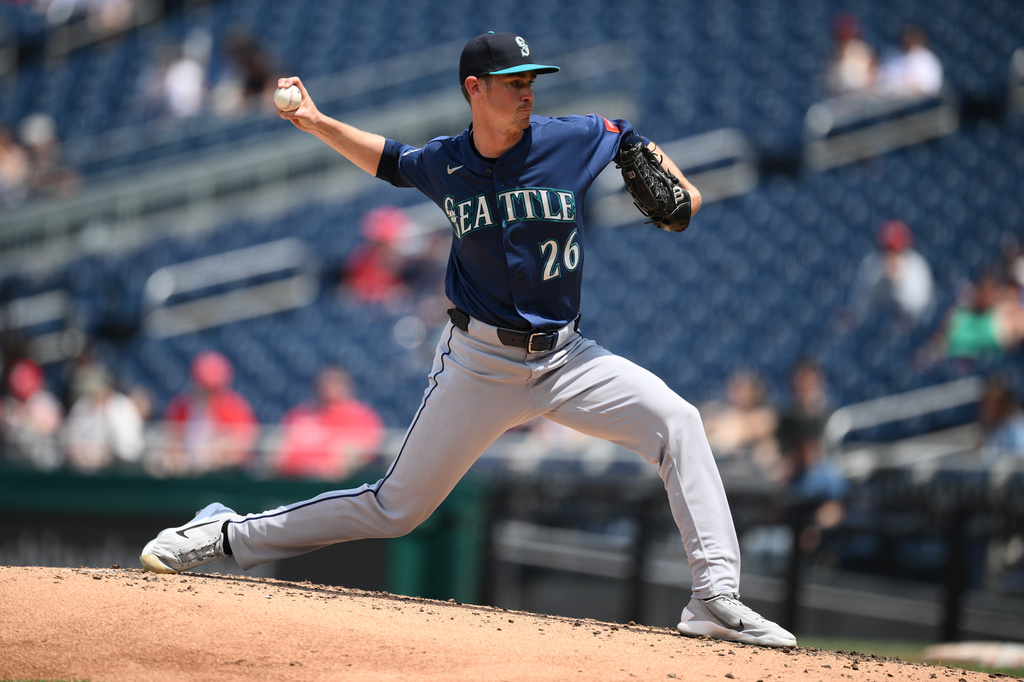 Seattle Mariners pitcher in a blue uniform delivering a pitch from the mound