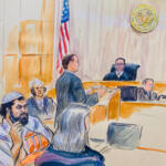 Courtroom scene with a judge at the bench, a lawyer speaking, and several attendees, an American flag in the background