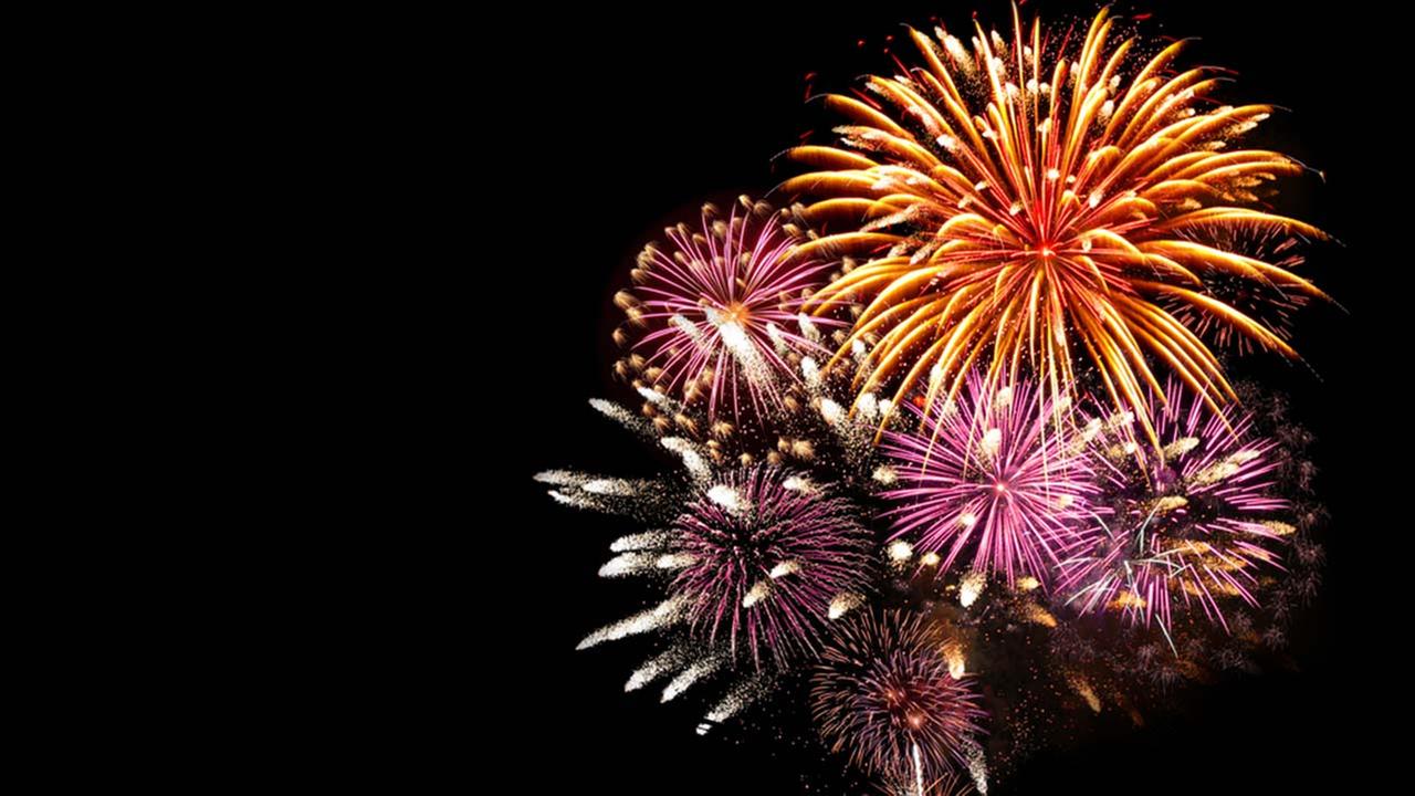 Colorful fireworks exploding in the night sky against a black background.
