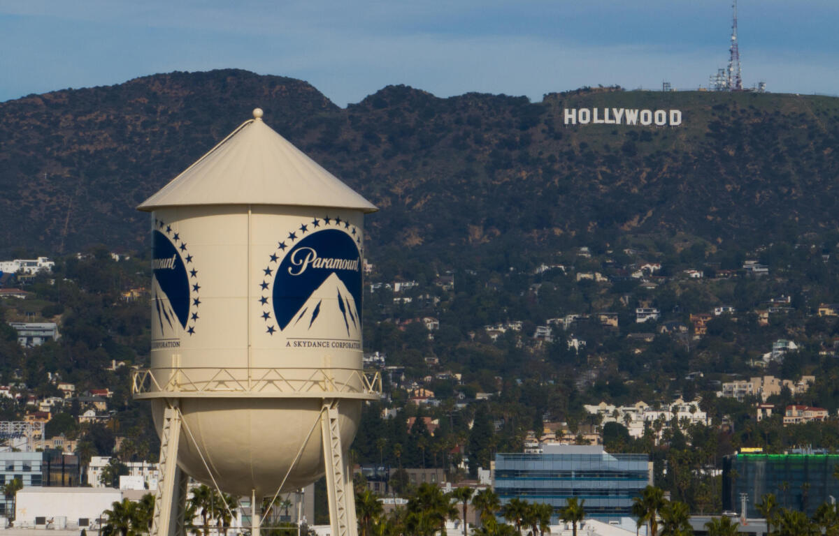 Water tower with Paramount logo in the foreground, hills and the Hollywood sign visible in the background.
