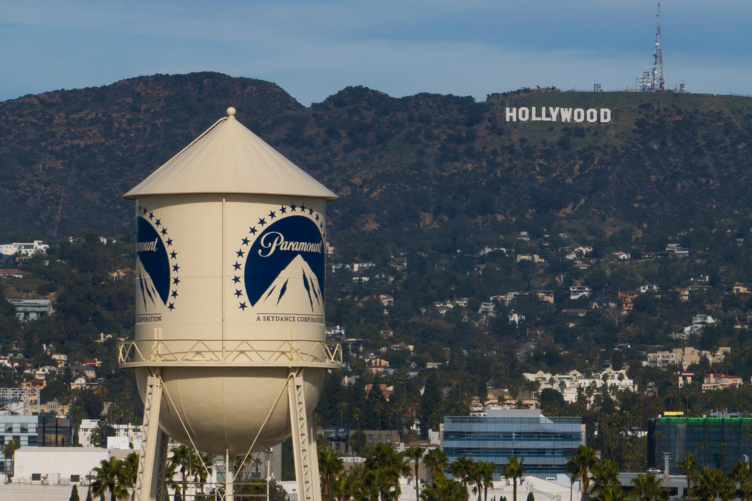 Water tower with Paramount logo in the foreground, hills and the Hollywood sign visible in the background.