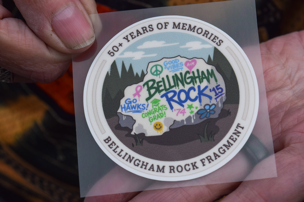 Circular sticker celebrating Bellingham Rock Fragment; graffiti-style rock with 'Go Hawks!', 'Congrats Grad!', and 'Rock ’15' in a forest scene; outer edge reads '50+ Years of Memories'