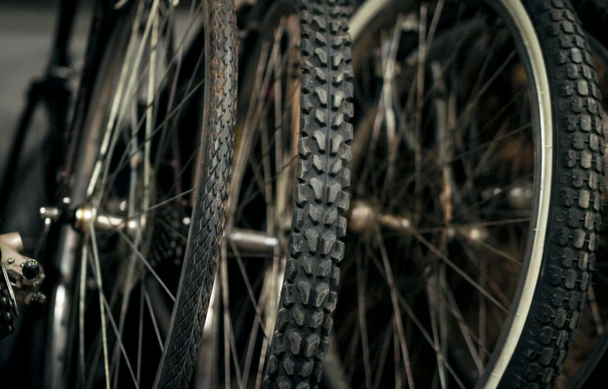 Close-up of knobby mountain bike tires with textured treads and spokes in the background