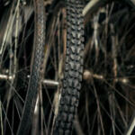 Close-up of knobby mountain bike tires with textured treads and spokes in the background