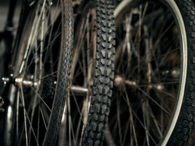 Close-up of knobby mountain bike tires with textured treads and spokes in the background