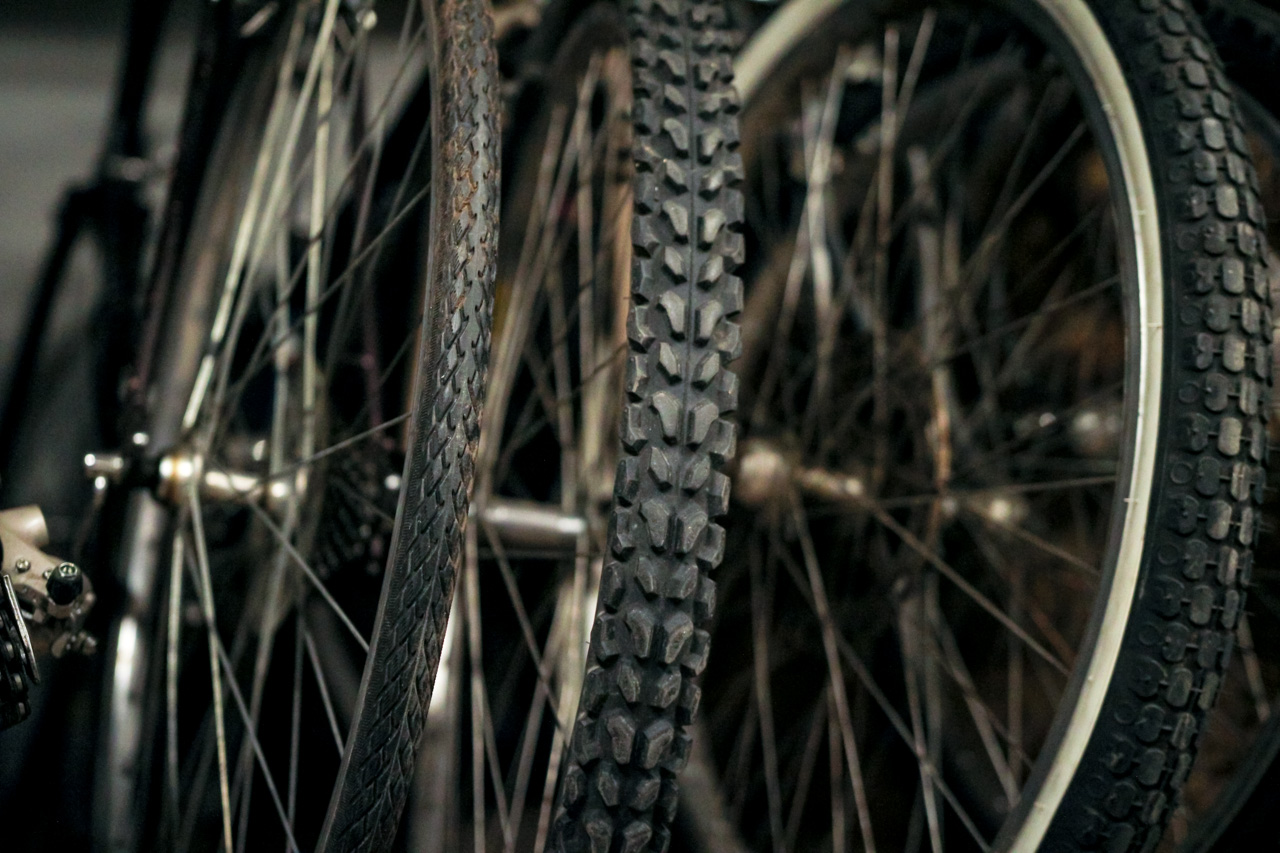 Close-up of knobby mountain bike tires with textured treads and spokes in the background