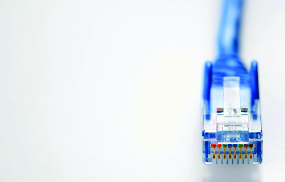 Close-up of a blue RJ-45 Ethernet connector with gold contacts at the right edge on a white background, taken from the side